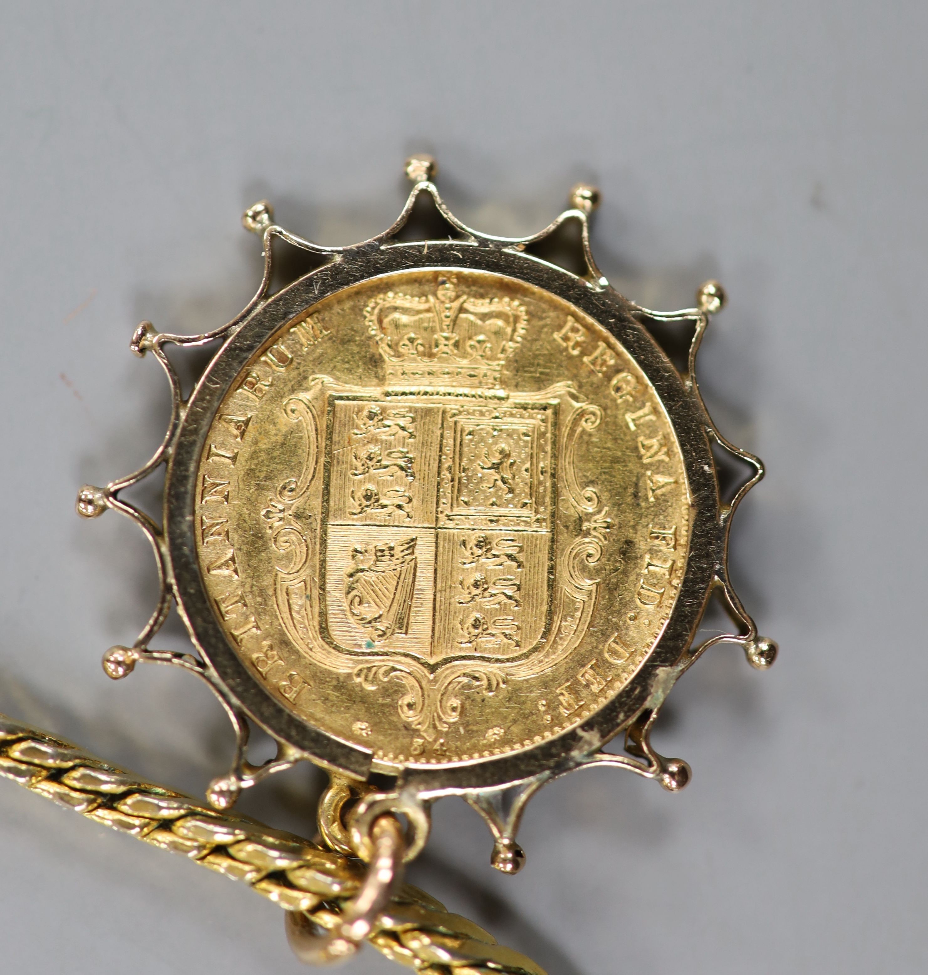 An 1878 gold half sovereign, in yellow metal pendant mount, on a gilt metal chain.